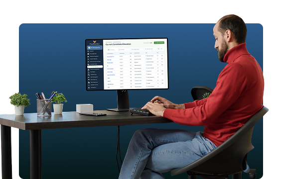 Recruiter working at a desk with the FoxMatrix ATS dashboard on screen