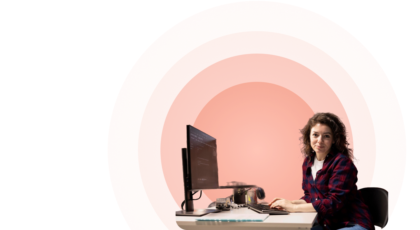Candidate completing a coding assessment at a dual-monitor workstation